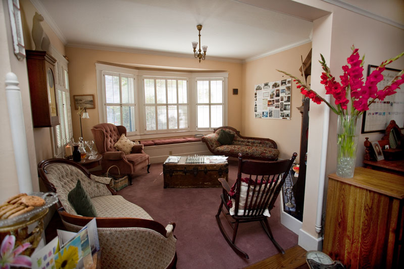 The lounge, with armchairs, a rocking chair and a bay window